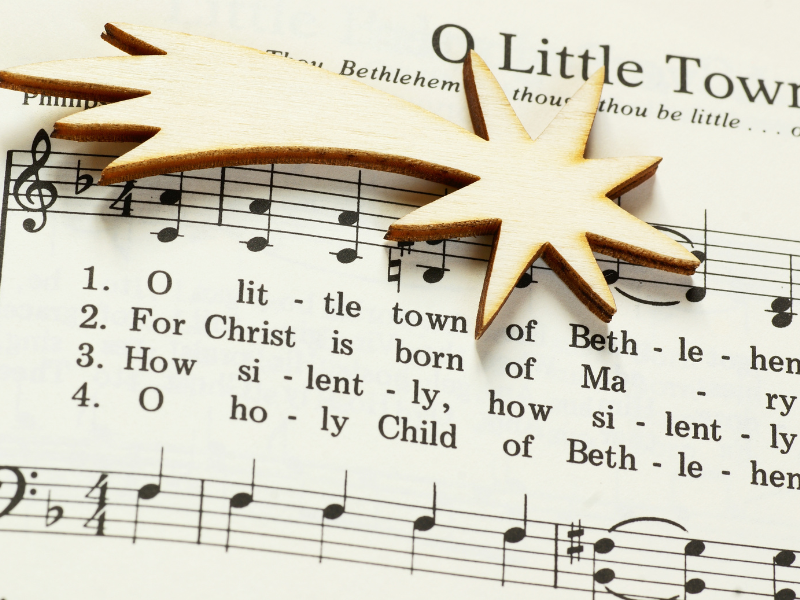 commercial christmas lights - christmas music sheet with gold star decoration on top