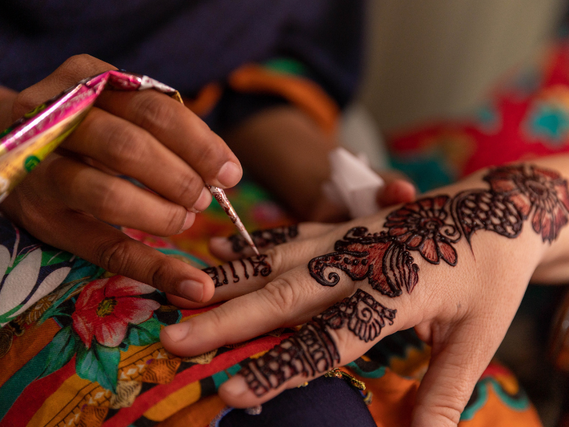 office halloween costume ideas - person getting a temporary henna tattoo